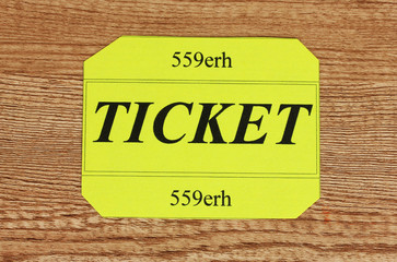 Colorful ticket on wooden background close-up