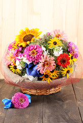 Fototapeta na wymiar Beautiful bouquet of bright flowers in sacking