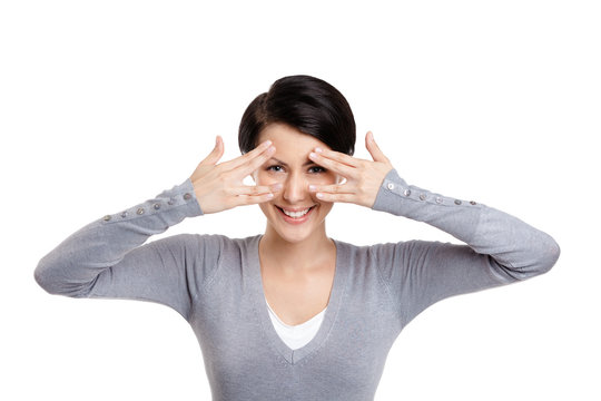 Young woman covers her eyes with hands, isolated on white