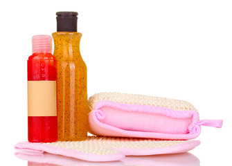 Bottles with scrub and sponges isolated on white