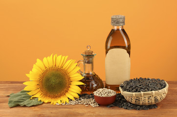 Fototapeta na wymiar sunflower oil and sunflower on yellow background