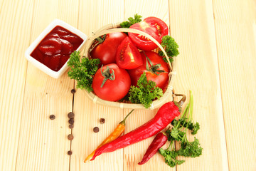 Still life tomatoes ketchup and herbs on wooden table