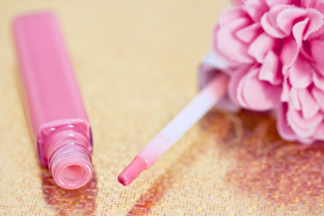 Obraz na płótnie Canvas pink lipgloss with flower petals