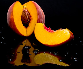 Peaches shot against black and giving a nice reflection