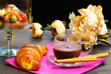 chocolate cup with fancy cakes and floral decorations