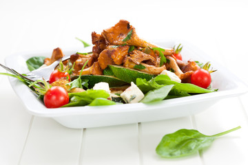 Fresh baby spinach with roasted chanterelle mushrooms