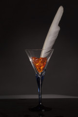 glass with feather