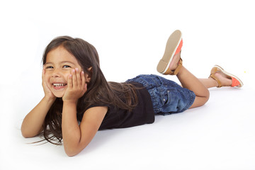 enfant souriante allong&eacute;e sur fond blanc