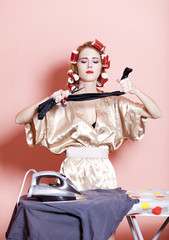 Obraz na płótnie Canvas Housewife with iron and curler
