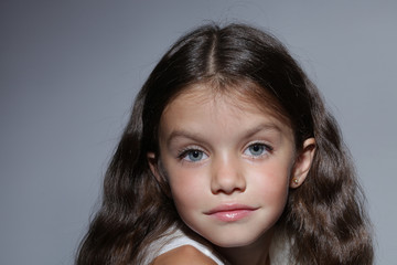 close up portrait of young beautiful little girl with dark hair