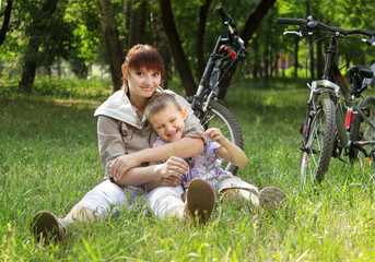 Naklejka na ściany i meble family on bike cycling in park