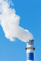 industrial smoke from chimney on blue sky