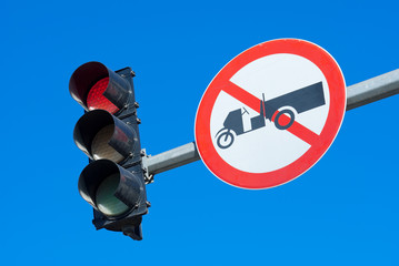 Red traffic light against a bright blue sky