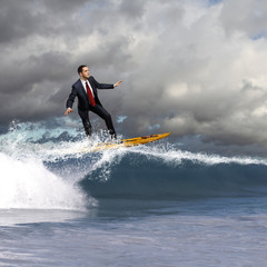 Young business person surfing on the waves - obrazy, fototapety, plakaty