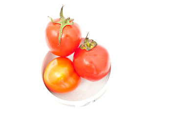 tomatos in chinaware on white paper