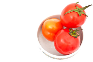tomatos in chinaware on white paper