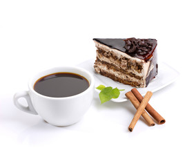 still-life composed of chocolate cake, coffee and green leafage