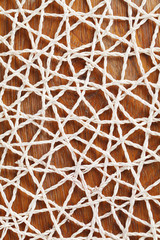 Fototapeta premium Abstractedly looking straw mat on wooden background