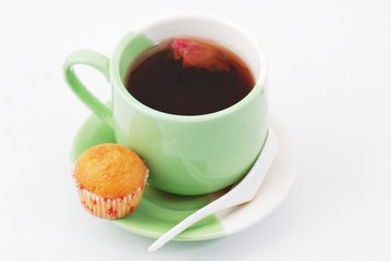 Tea being poured into tea cup isolated on a white background