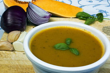 Bowl of yellow squash soup with onion and squash