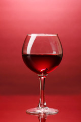 Wineglass on red background