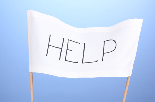 Fototapeta Help written on white cloth on blue background