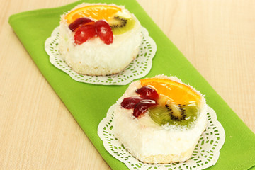 sweet cake with fruits on wooden table