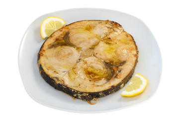 fried swordfish with lemon on the white plate
