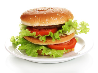 Big and tasty hamburger on plate isolated on white