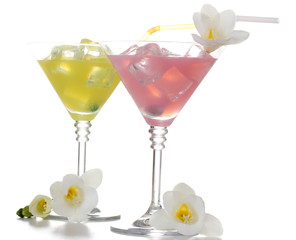 martini glasses of cocktails with ice and flowers isolated