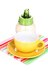 Yellow cup and saucer isolated on white