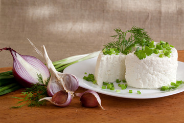 cottage cheese with greens and onions on a plate