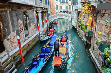 typical urban view with canal, boats and houses in Venice