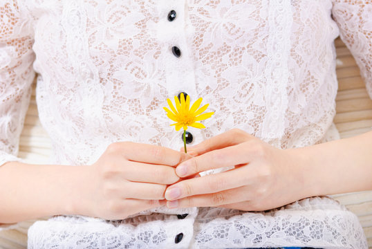 woman detail with a flower in her hands