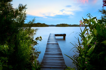 wooden pier in summer on lake