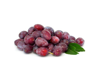 Many fresh plums with leaves isolated on white background