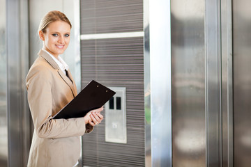 young businesswoman waiting for elevator in the building