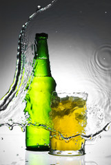 Beer bottle with water splash