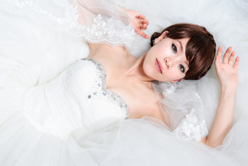 bride sitting in wedding dress, studio shot