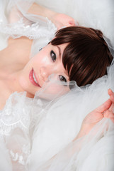 bride sitting in wedding dress, studio shot