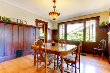 Nice dining room with wood walls and hardwood floor.