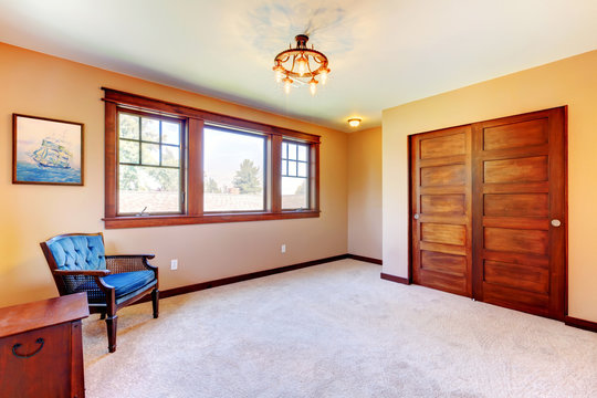 Empty nice bedroom room with wood trim and blue chairs