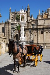 Fototapeta na wymiar Horse drawn carriage and Cathedral, Seville © Arena Photo UK