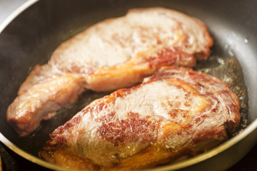 beef steak in a frying pan