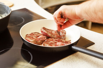 beef steak in a frying pan