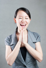 Happy Asian woman with her arms in the air cheering