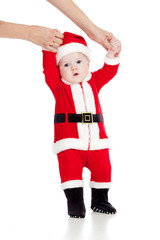 first steps of child dressed as Santa claus