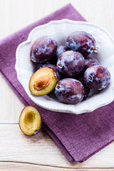 Fresh plums in a bowl