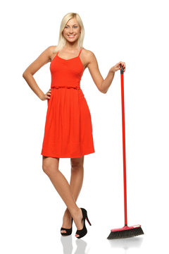 Full Length Of Smiling Woman Standing With Broom