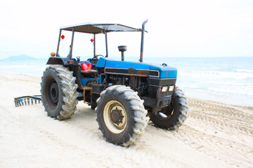 old tractor on sand beach